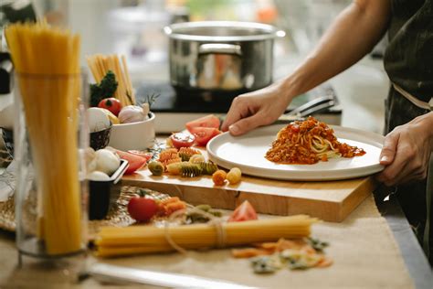 Person Cooking Pasta With Meat And Tomatoes · Free Stock Photo