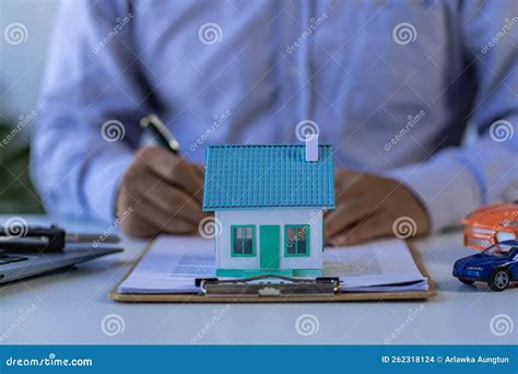 Real Estate Agent Or Bank Officer Working With Paperwork And Laptop