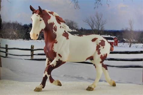 A Toy Horse That Is Standing In The Snow