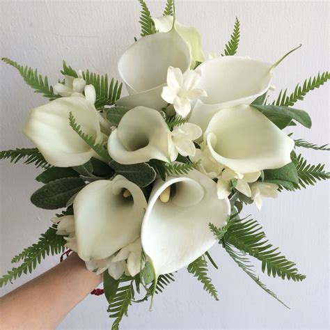 A Fresh White Calla Lily Bridal Bouquet Stephanotis And Fern Leaves