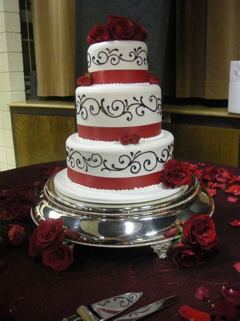 A modern wedding cake designed with black and white fondant stripes on the bottom tier. Black, red and white wedding cake (148) | black scroll ...