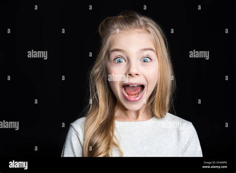 Cute Blonde Girl Screaming And Looking At Camera On Black Stock Photo Alamy