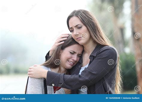 Sad Woman Crying And A Friend Comforting Her Stock Photo Image Of