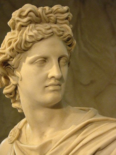 A Close Up Of A Statue Of A Man With Curly Hair Wearing A White Dress