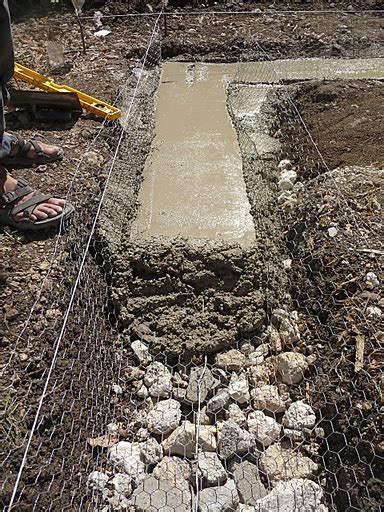 Once the concrete has cured, use concrete block to create the stem walls if you're building a basement. Earthbag Foundation