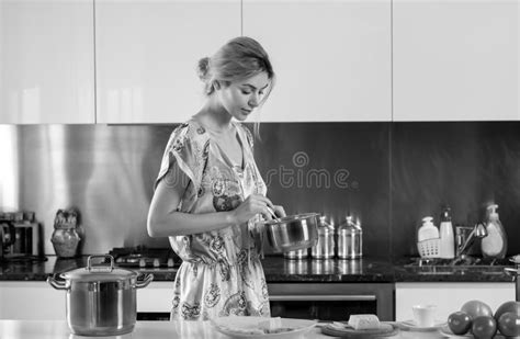 Woman With Cooking Pot In A Kitchen Housewife On Morning Housework