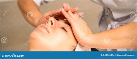 Facial Massage Young Caucasian Woman With Closed Eyes Getting A Massage On Her Forehead In A