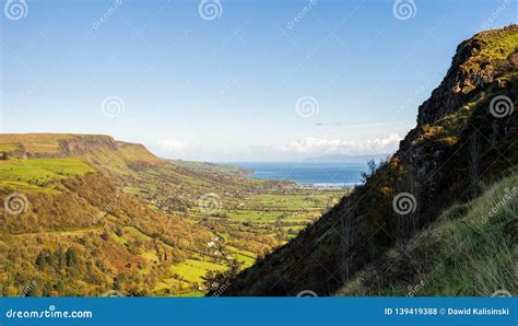 A Steam Side Of A Mountain And Vast Valley Below With Cliffs And Sea