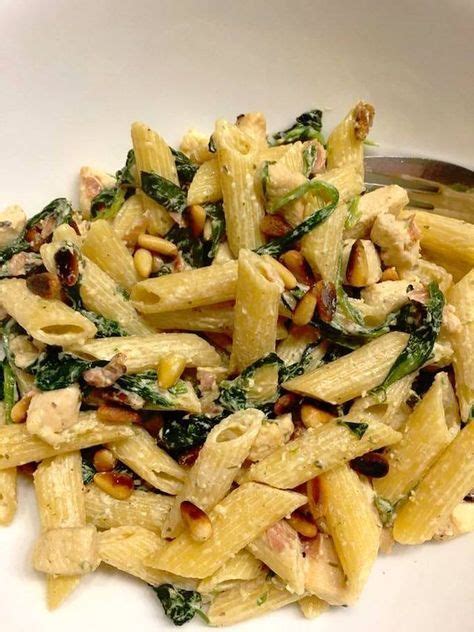 Pasta With Spinach And Pine Nuts In A White Bowl
