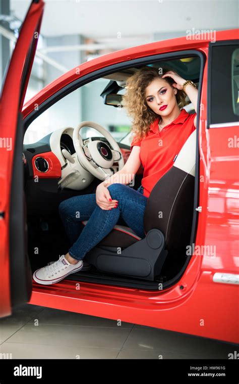 Beauty Woman In Small Red Car Posing Stock Photo Alamy