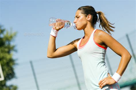Young Beautiful Athlete Drinking Water After Exercising Stock Photo By
