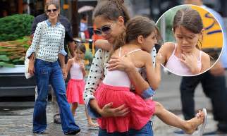 suri cruise looks wary dodging puddles in ballerina pink and flip flops so mummy katie holmes