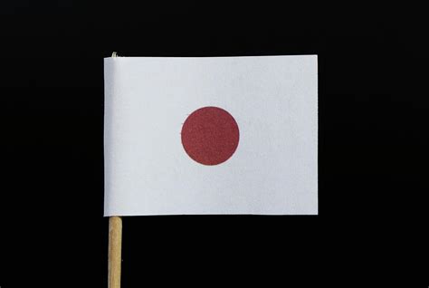 A National And Official Flag Of Japan On Toothpick On Black Background