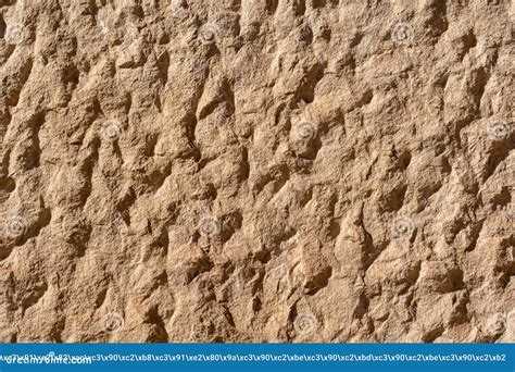 Texture Of A Natural Rough Cut Stone Of An Ancient Building Stock Photo