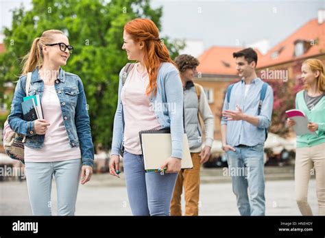 Young College Friends Walking On Street Stock Photo Alamy