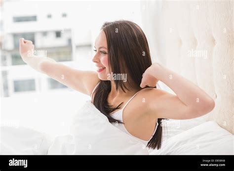 Pretty Brunette Waking Up In Bed Stock Photo Alamy