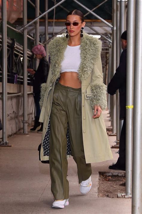bella hadid shows off her toned abs in a white crop top as she heads into the marc jacobs show