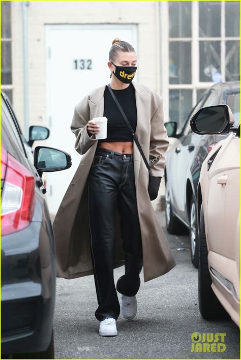 hailey bieber rocks her long trench coat on multiple errands after weekend road trip photo