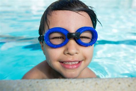 Premium Photo Portrait Of Smiling Boy With Swim Goggles Swimming In