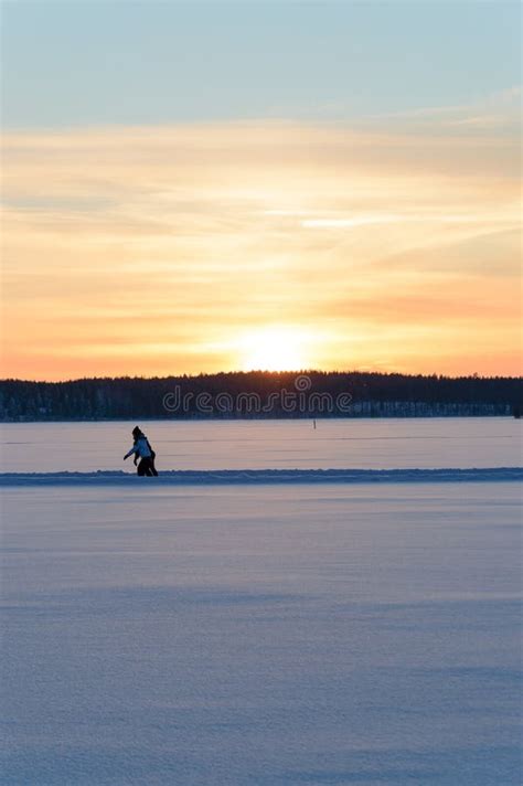 Ice Skating In Skandinavien Winter Sunset On Frozen Lake Stock Image