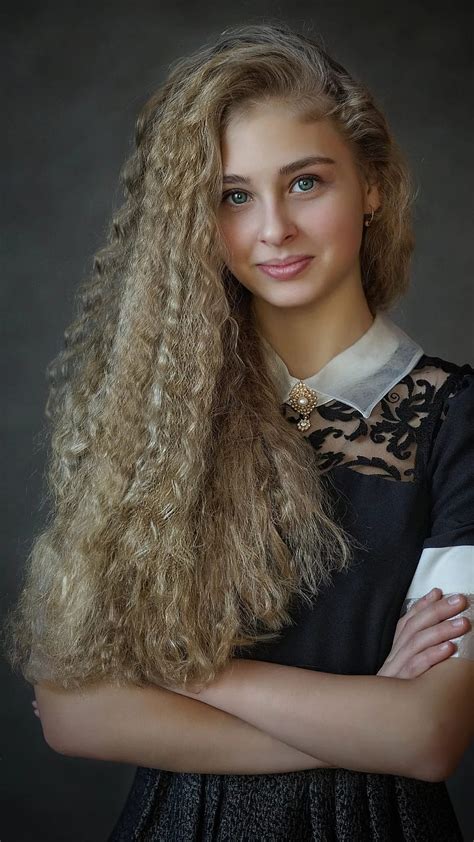 girl with brown curly hair and blue eyes