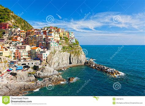 Village On A Cliff Over The Ocean With The Sunset In The Background