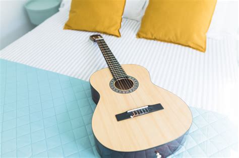 .bed in bedroom light with beautiful smile looking at camera jumping on the bed stock video young woman jumping on the bed, she fools around in the bedroom when i dream at night best. Wooden guitar on bed in bedroom | Free Photo