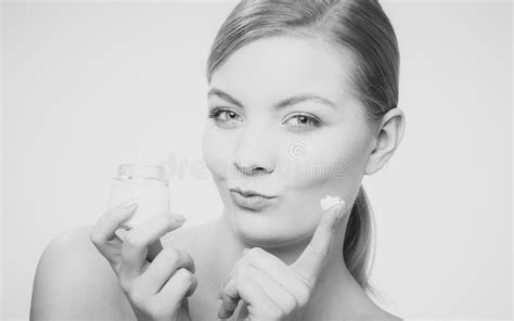 woman applying cream on her skin face stock image image of cosmetics cream 76759257