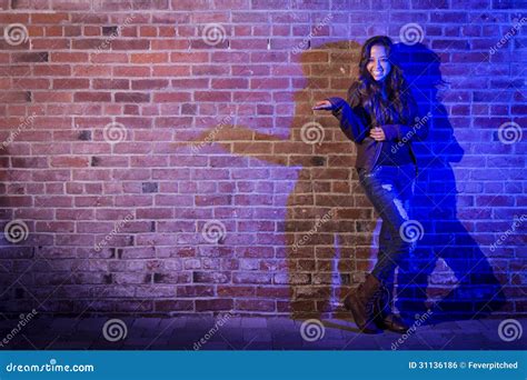 Mixed Race Woman Holding Her Hand Out Against Brick Wall Royalty Free