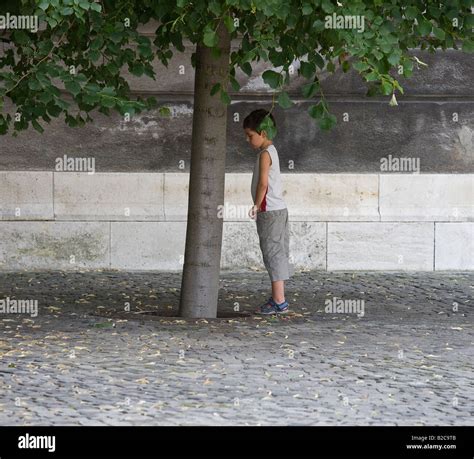 Boy Pissing Against Tree Stock Photo Alamy