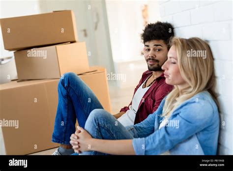 Tired Couple With Boxes Moving Into New Home Stock Photo Alamy