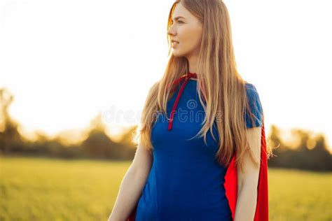 Joyful Beautiful Woman In A Superhero Costume Posing Against The