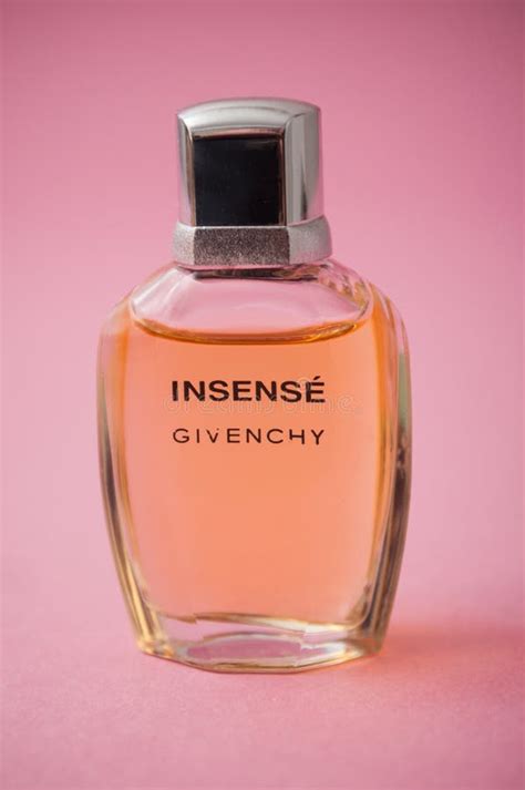 Insense Of Givenchy Perfume In A Transparent Bottle On Pink Background