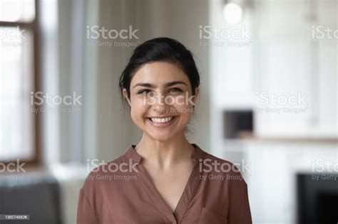 Indian Female With Wide Smile Standing Indoor Posing On Camera Stock