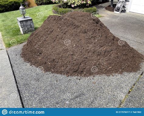 Pile Of Fresh Topsoil In Home Driveway For Lawn Maintenance Stock Image