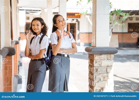 Two High School Teenage Girls Smiling With Okay Hand Gestures Stock