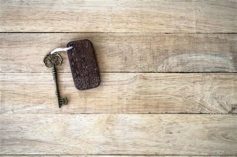 Vintage House Key With Wooden Home Keyring On Old Wood Background Stock