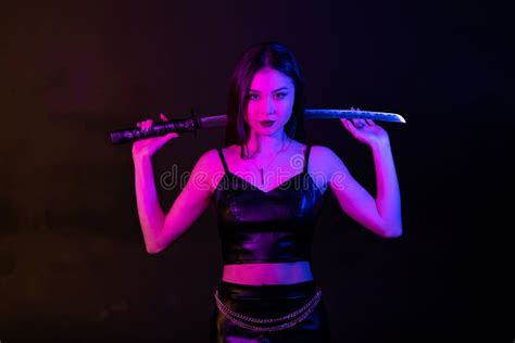 Beautiful Asian Girl With Katana Sword In Neon Lights Stock Image