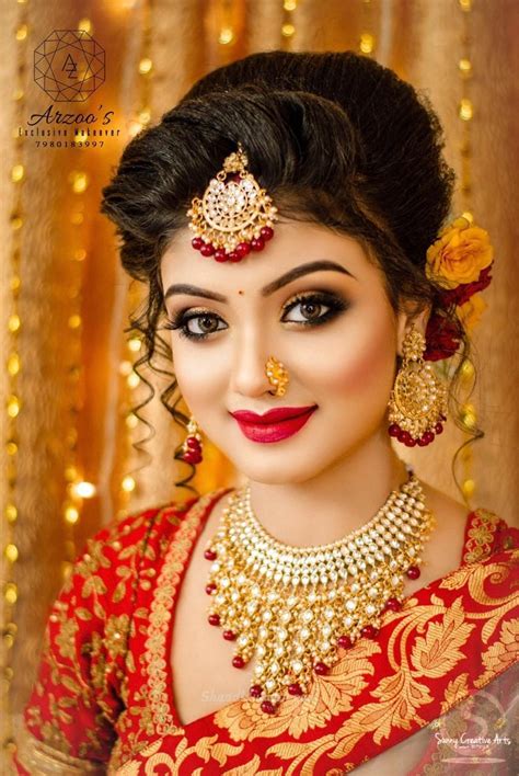 From flower braids to accessorized buns, here are our favorite ideas for reception hairstyles for brides and hairdos for indian wedding guests. Elegant bridal Makeup images #bengalibride #bridalmakeup # ...