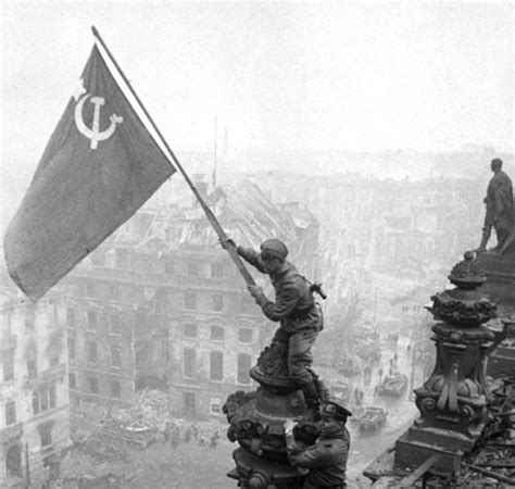 Russian Soldiers Raise A Red Victory Flag Over The Reichstag In Berlin