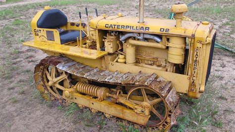 An Old Yellow Tractor Sitting In The Dirt