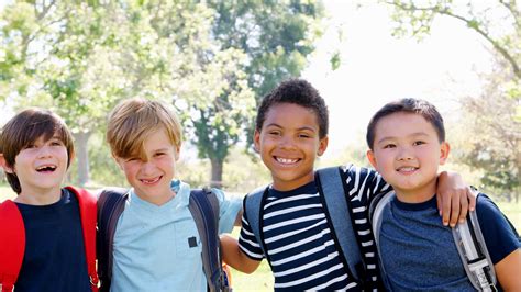 Portrait Of Group Of Young Boys With Friends In Park Shot In Slow