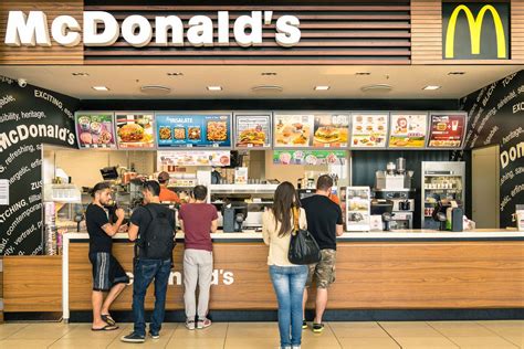 Mcdonald's garbage or disposable trash on dark brown wooden background. McDonald's Customer Chokes Cashier Over Order Mix-Up - Eater