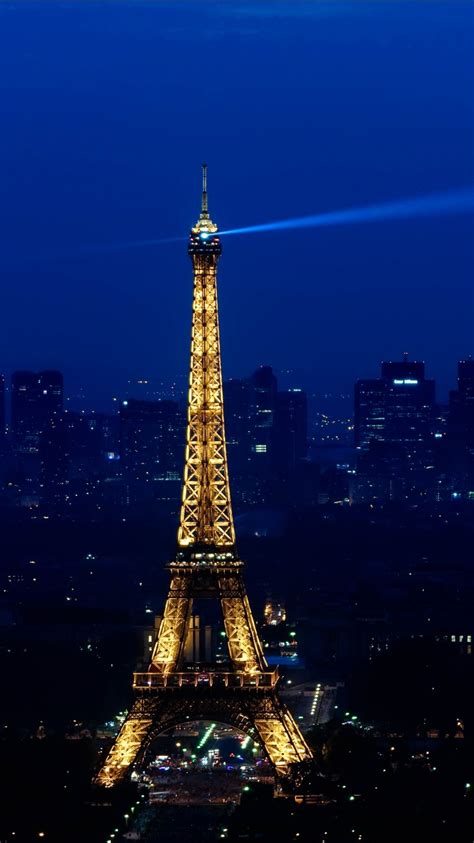 Paris Eiffel Tower With Blue Light On Top With Blue Sky Background