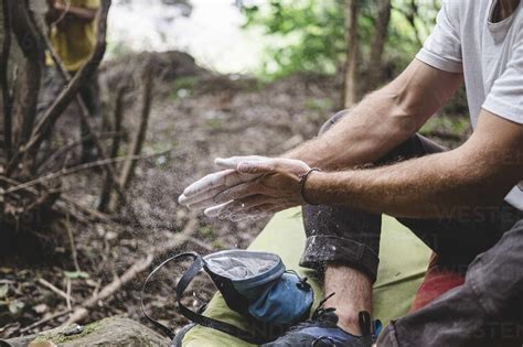 Close Up Of Rock Climber Hands Clapping Hands With Chalk Stock Photo