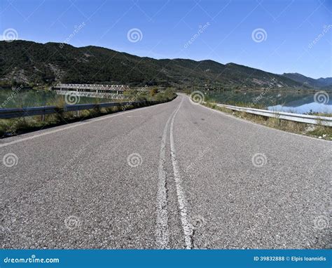 An Empty Road Next To A Lake Stock Photo Image Of Countryside