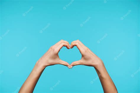 Free Photo Close Up On Elegant Raised Hands Forming Heart With