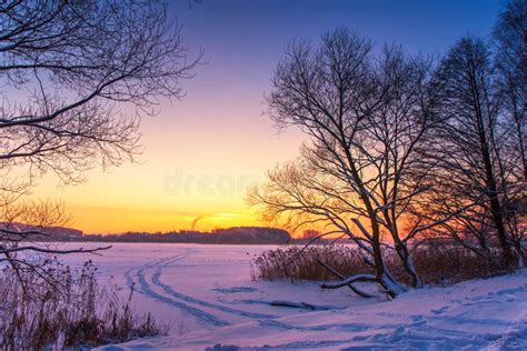 Colorful Winter Sunset With Frozen Lake And Sunset Sky Stock Photo