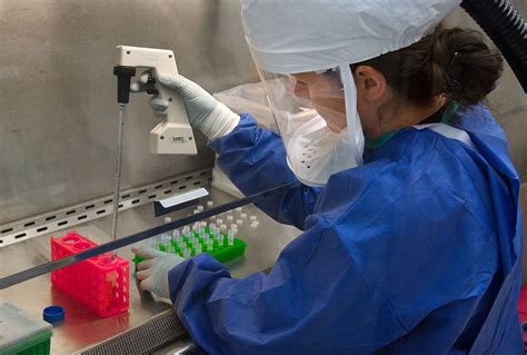 Woman Wearing Blue Laboratory Dress Holding White Tester Test
