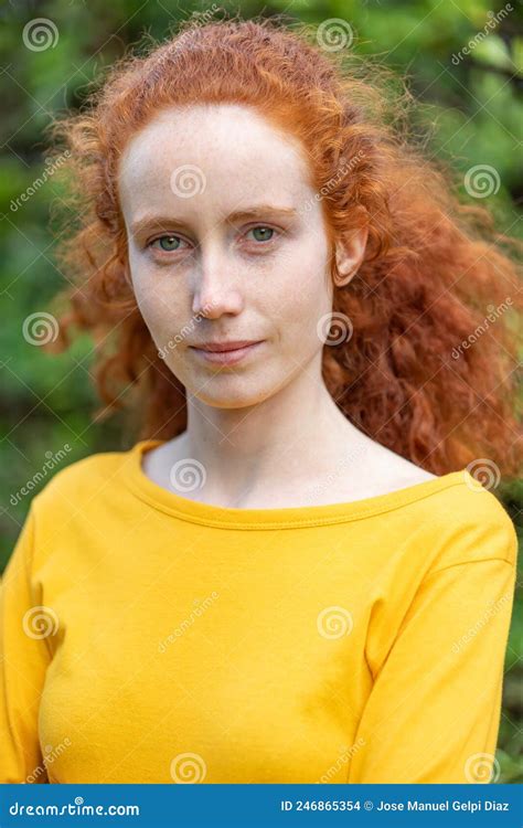 Lose Up Portrait Of A Red Hair Woman Girl With Freckles Looking At